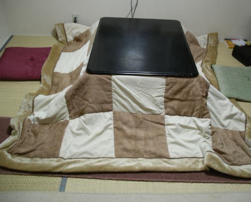 A kotatsu is a low table frame covered by a blanket which the tabletop sits 